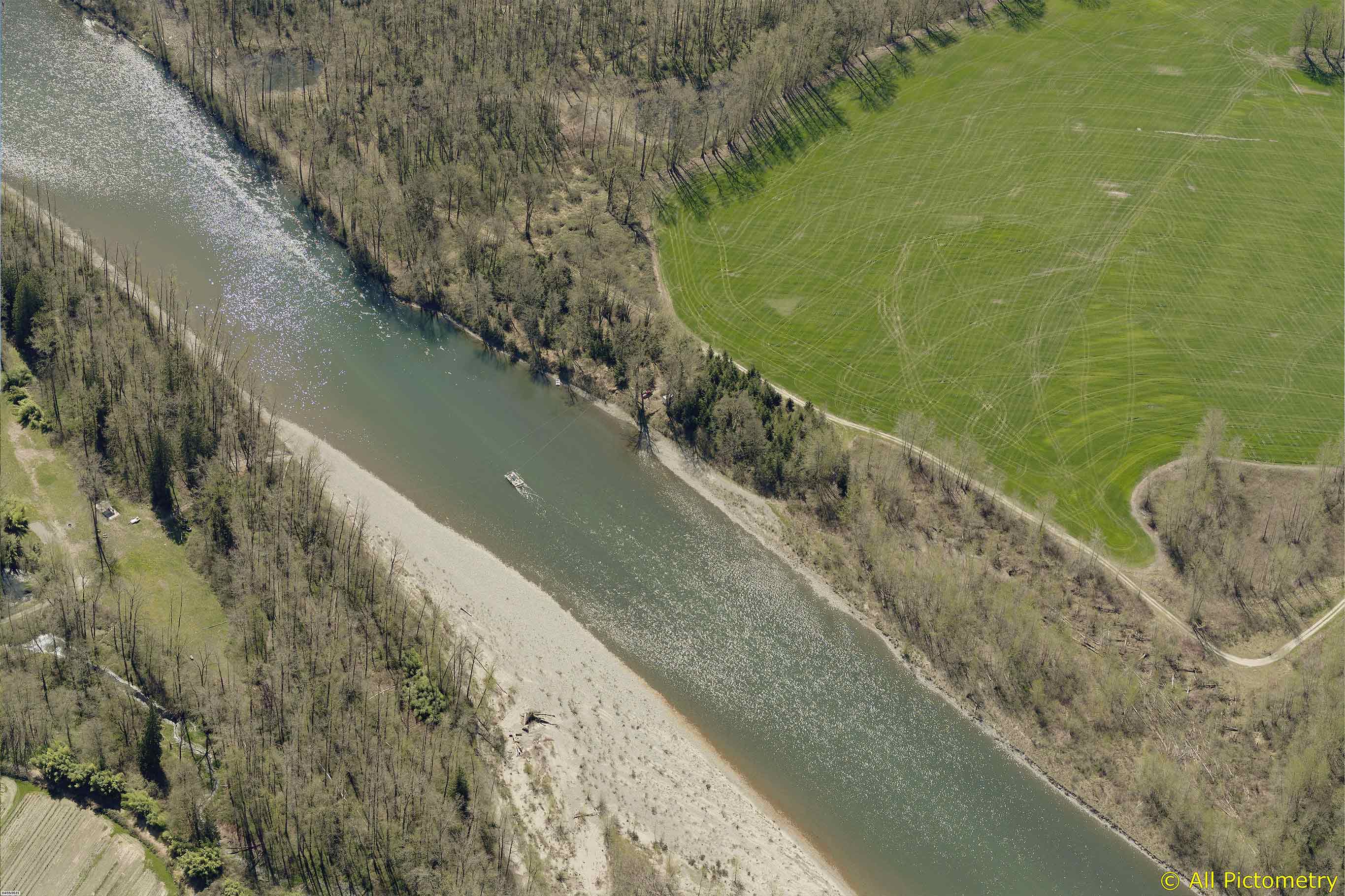 Tualco Valley high-up aerial of the river meandering through Snohomish plush farmland and wooded areas
